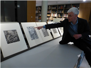 David Morris showing the new members a selection of exquisite prints & telling the story behind them.